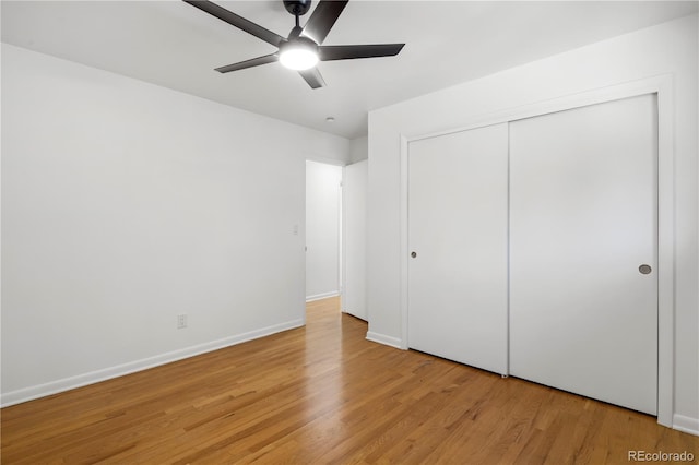 unfurnished bedroom with light wood-type flooring, a closet, and ceiling fan