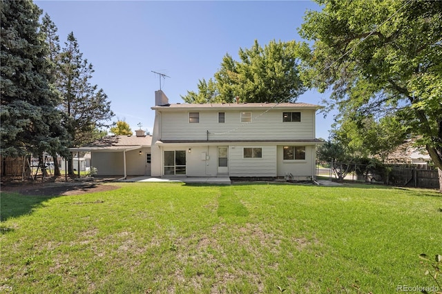 rear view of property with a patio area and a yard