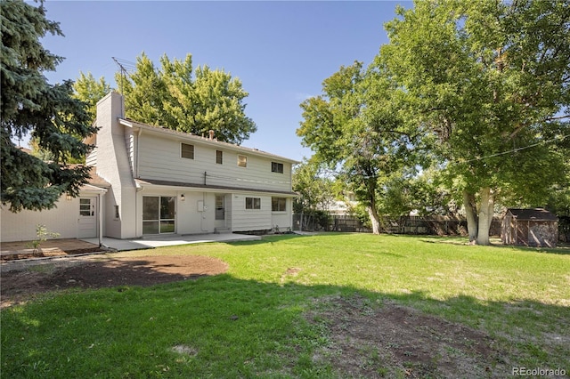 back of house with a yard, a storage shed, and a patio