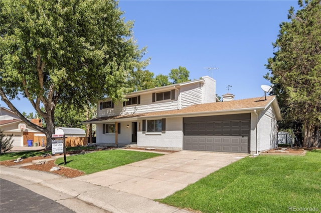 view of front property featuring a garage and a front lawn