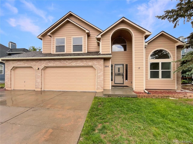 584 W Prestwick Way, Castle Rock, CO 80104 - traditional home with concrete driveway, a front yard, brick siding, and a garage