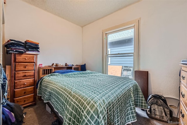 bedroom with carpet flooring and a textured ceiling