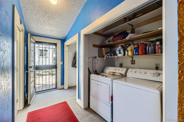 laundry room with laundry area, a textured ceiling, independent washer and dryer, baseboards, and light carpet