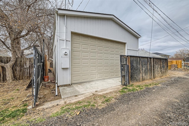 detached garage featuring fence