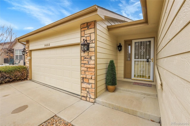 property entrance with stone siding and an attached garage