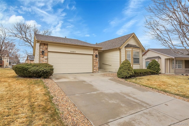 single story home with an attached garage, stone siding, a front lawn, and concrete driveway