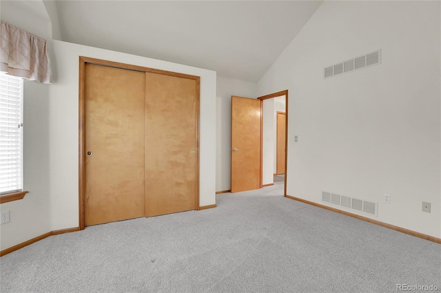 unfurnished bedroom with light colored carpet, a closet, visible vents, and baseboards