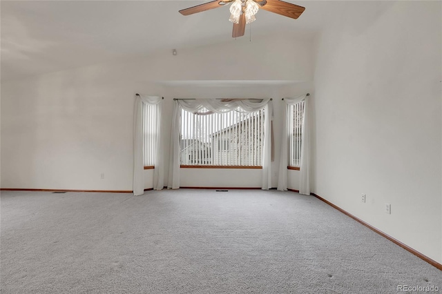 carpeted empty room with ceiling fan and baseboards