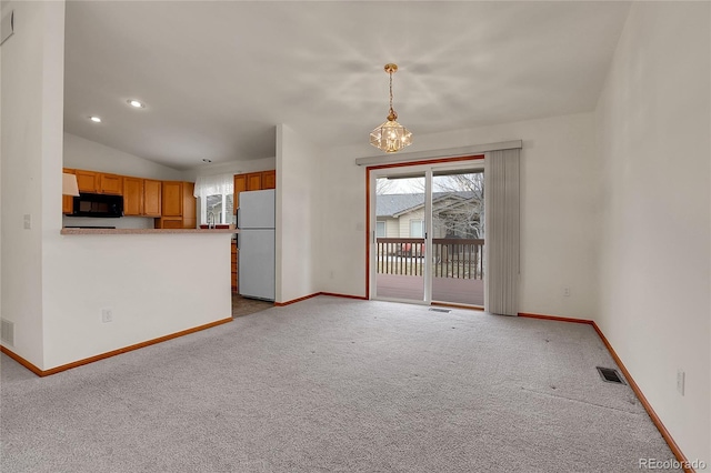 interior space featuring vaulted ceiling, carpet flooring, visible vents, and baseboards