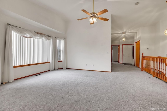 unfurnished room featuring light carpet, a high ceiling, and visible vents