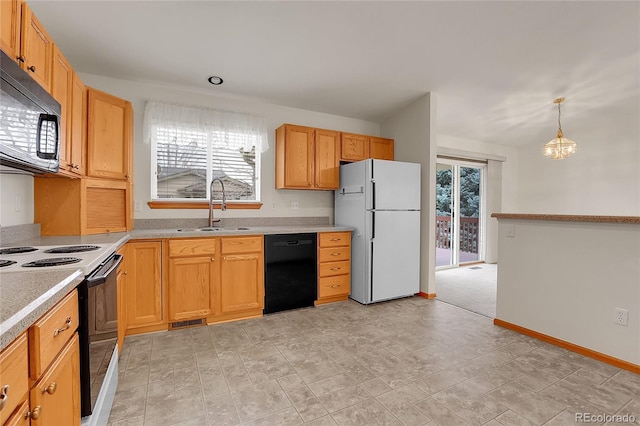 kitchen featuring black appliances, plenty of natural light, a sink, and light countertops