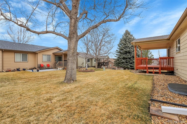 view of yard with a patio area and a wooden deck