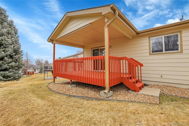 wooden deck featuring a lawn