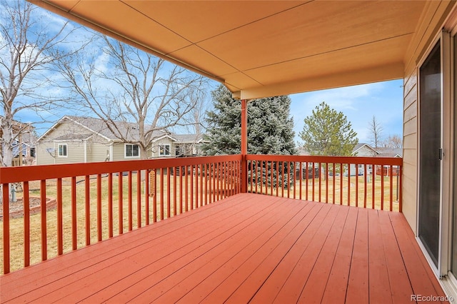 wooden deck with a residential view and a yard