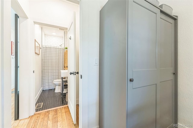 hall with light wood-type flooring and visible vents