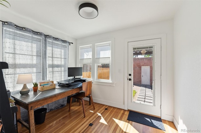 office with light wood-type flooring, plenty of natural light, and baseboards