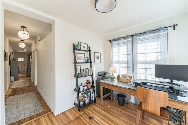 office with light wood-style floors and baseboards