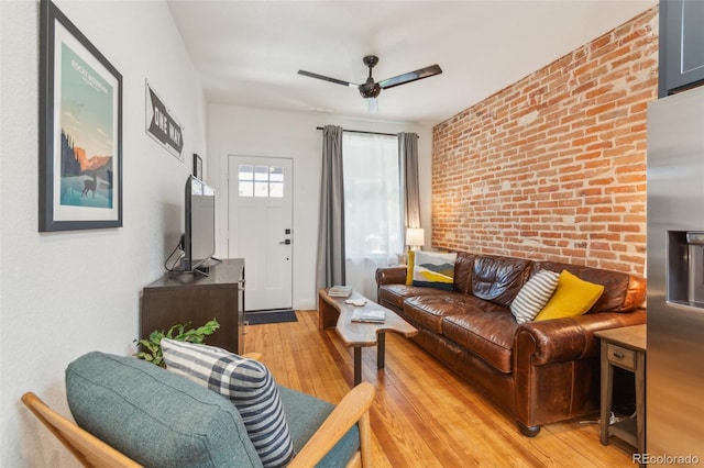 3329 N High St, Denver, CO 80205 - living room featuring light wood-type flooring, a ceiling fan, and brick wall