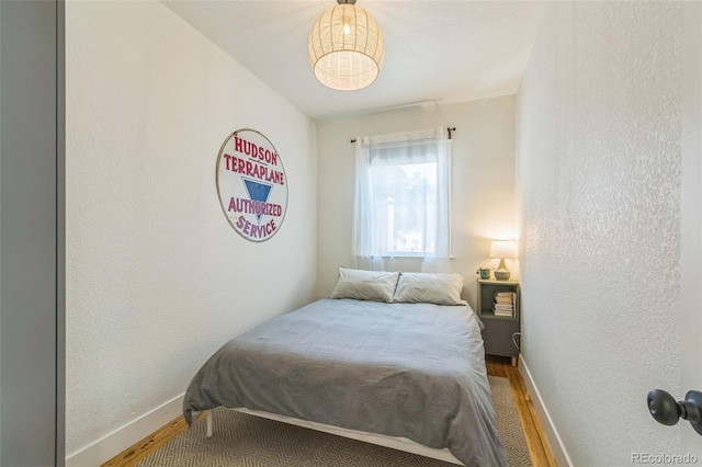 3329 N High St, Denver, CO 80205 - bedroom with wood finished floors, baseboards, and a textured wall