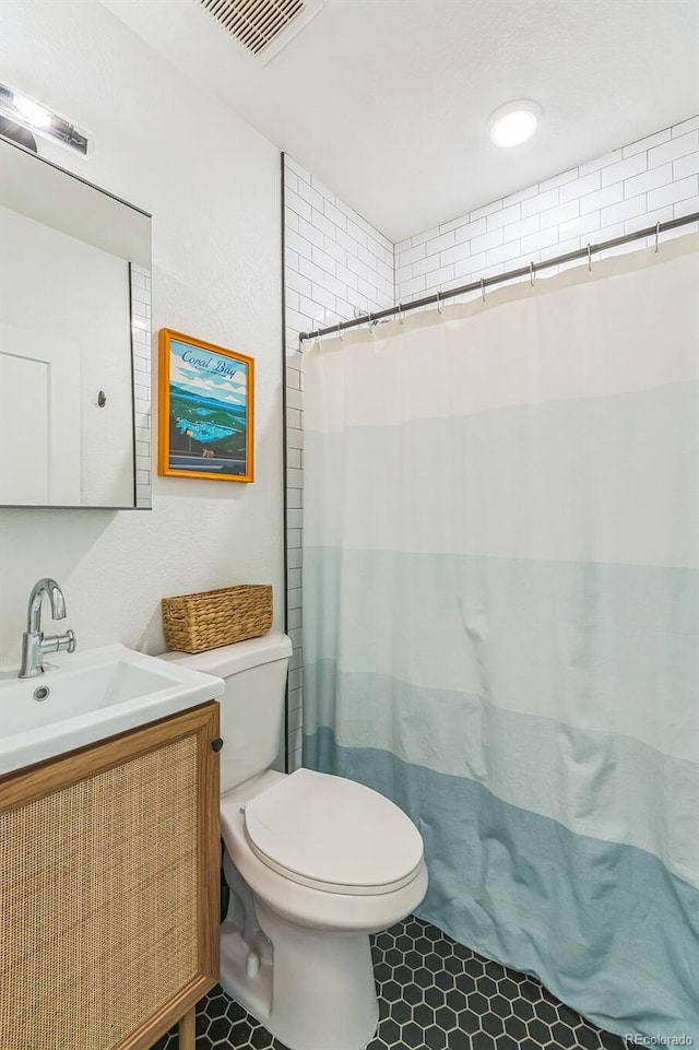 3329 N High St, Denver, CO 80205 - bathroom with toilet, tile patterned floors, curtained shower, visible vents, and vanity