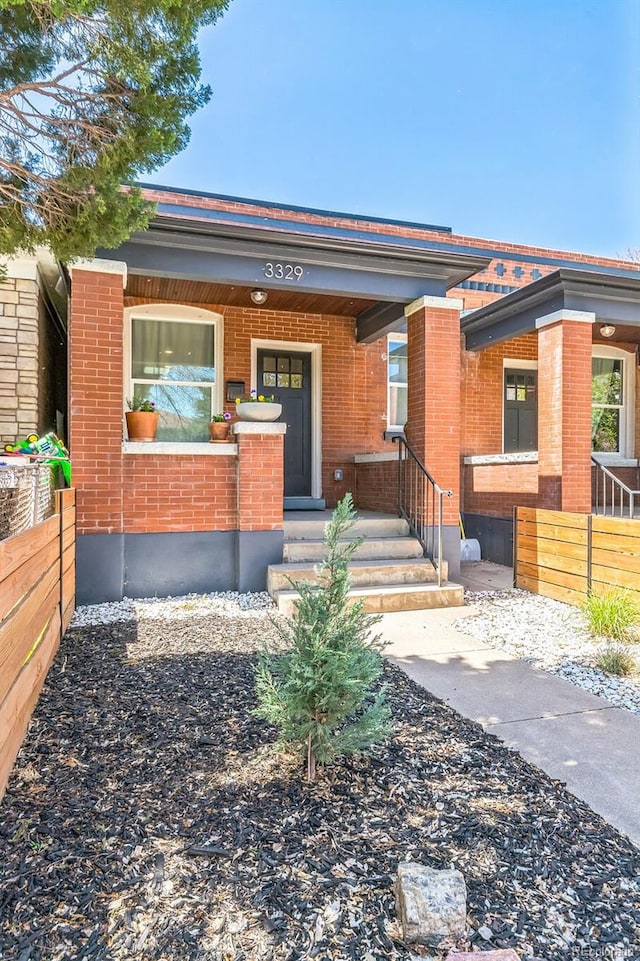 3329 N High St, Denver, CO 80205 - view of front of home with brick siding and fence