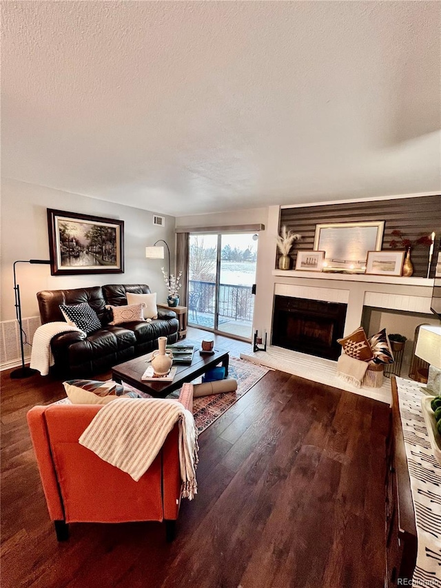 living room with wood-type flooring and a textured ceiling