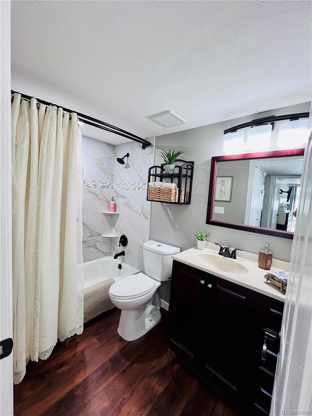 full bathroom featuring hardwood / wood-style flooring, vanity, toilet, shower / bath combo, and a textured ceiling