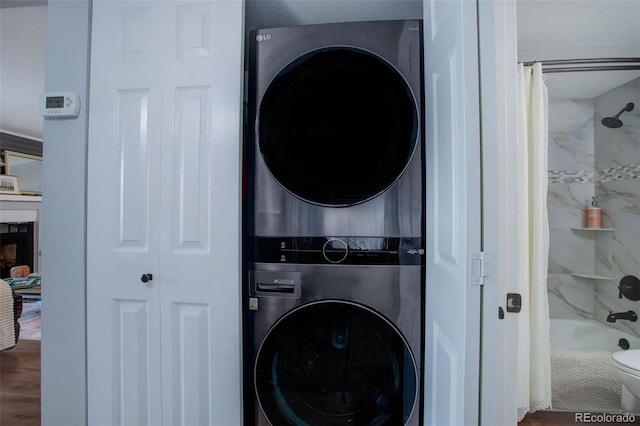 laundry area featuring stacked washing maching and dryer