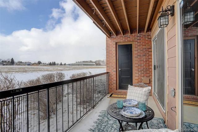 view of snow covered back of property