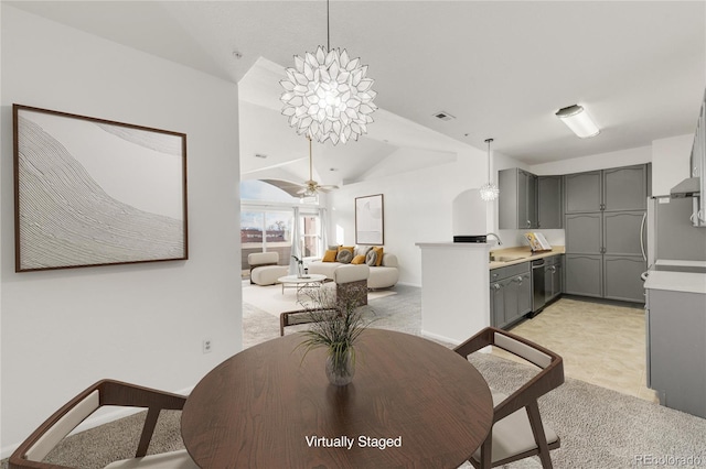 carpeted dining space with vaulted ceiling and ceiling fan