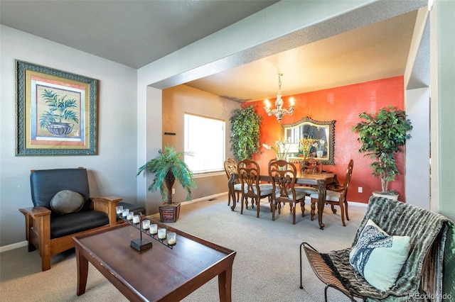 dining space with carpet flooring and an inviting chandelier