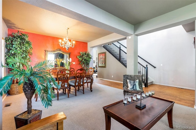 living room featuring carpet floors and an inviting chandelier