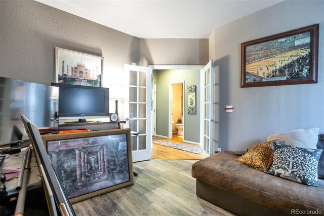 living room featuring light hardwood / wood-style floors and french doors