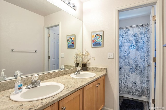 bathroom with a shower with curtain and vanity