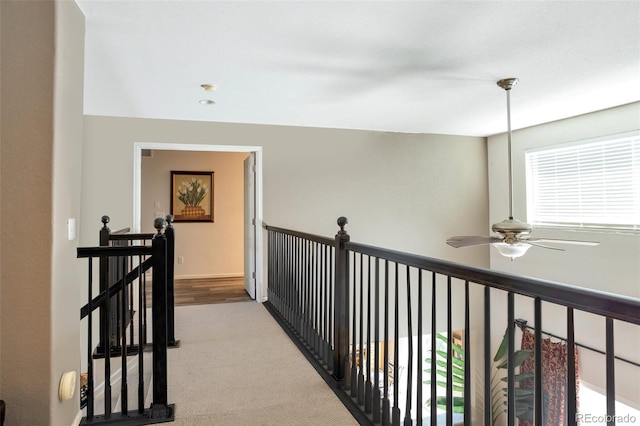 corridor featuring light colored carpet