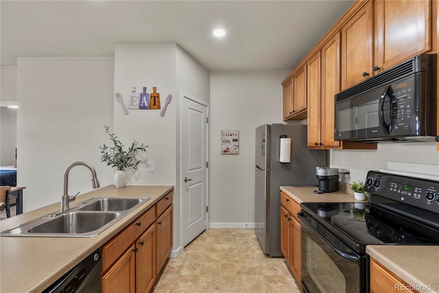 4100 Albion St Unit 424, Denver, CO 80216 - kitchen with black appliances, brown cabinets, light countertops, and recessed lighting