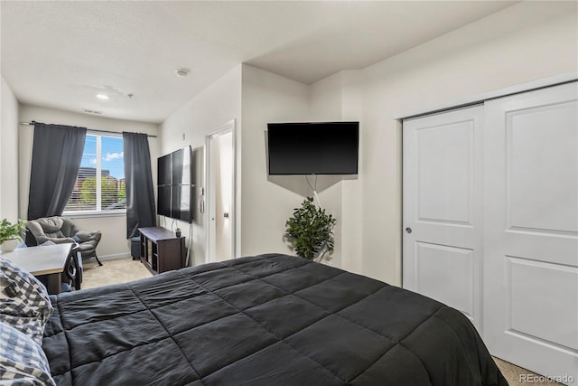 4100 Albion St Unit 424, Denver, CO 80216 - bedroom featuring light colored carpet, a closet, and recessed lighting