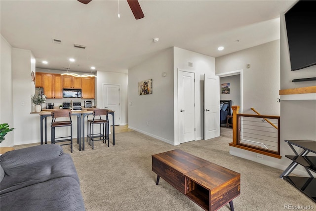 4100 Albion St Unit 424, Denver, CO 80216 - living room with recessed lighting, light carpet, and a ceiling fan