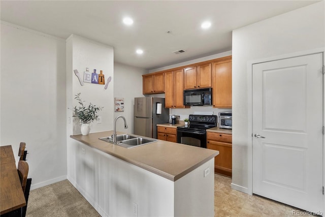 4100 Albion St Unit 424, Denver, CO 80216 - kitchen featuring black appliances, a peninsula, recessed lighting, and brown cabinetry