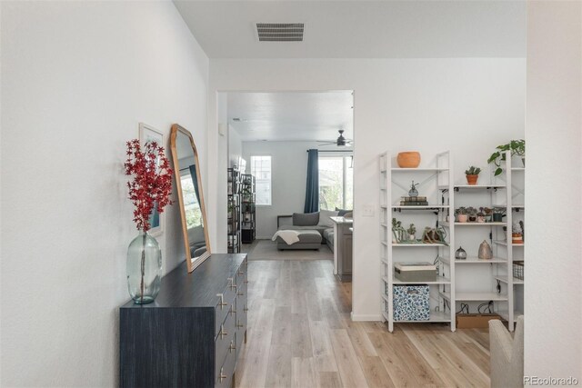 hallway with light hardwood / wood-style flooring