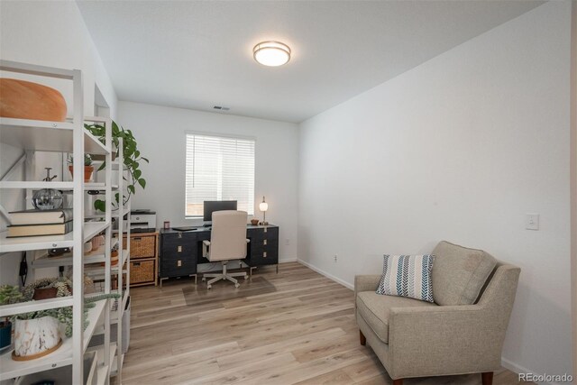 office with light hardwood / wood-style floors