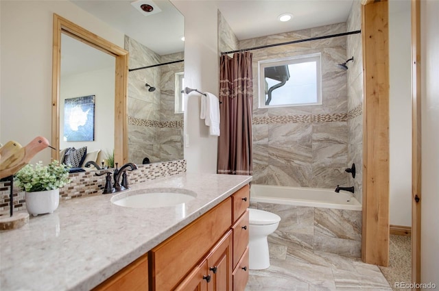 full bathroom with shower / bath combination with curtain, toilet, and vanity