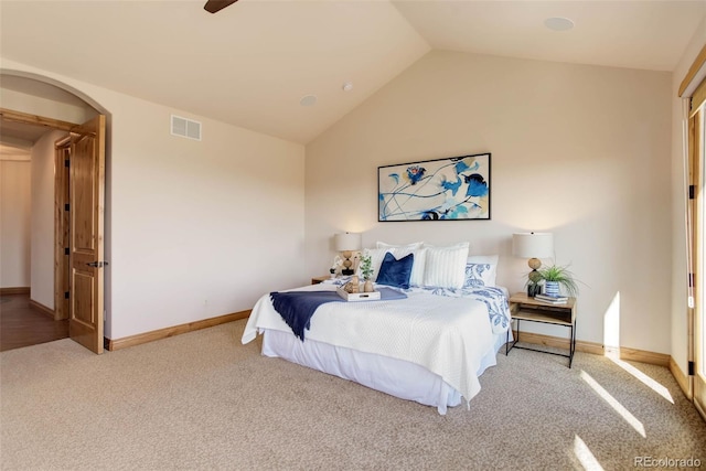 bedroom featuring light colored carpet, vaulted ceiling, and ceiling fan