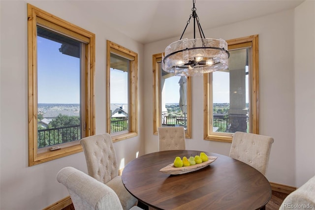 dining space featuring hardwood / wood-style flooring, plenty of natural light, and a chandelier