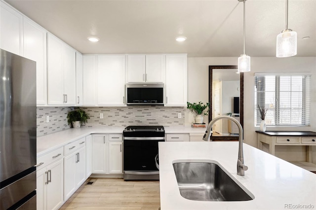 320 Marshall Mews, Superior, CO 80027 - kitchen with appliances with stainless steel finishes, a sink, light countertops, tasteful backsplash, and recessed lighting