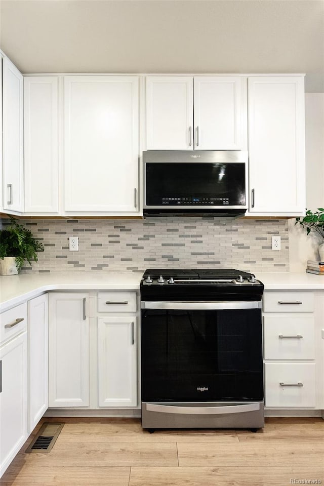 320 Marshall Mews, Superior, CO 80027 - kitchen with appliances with stainless steel finishes, white cabinetry, and light countertops