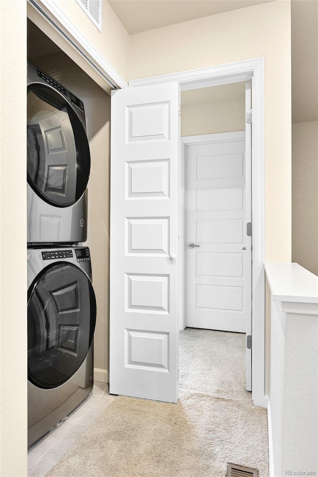 320 Marshall Mews, Superior, CO 80027 - laundry area with stacked washer / drying machine, carpet flooring, and baseboards