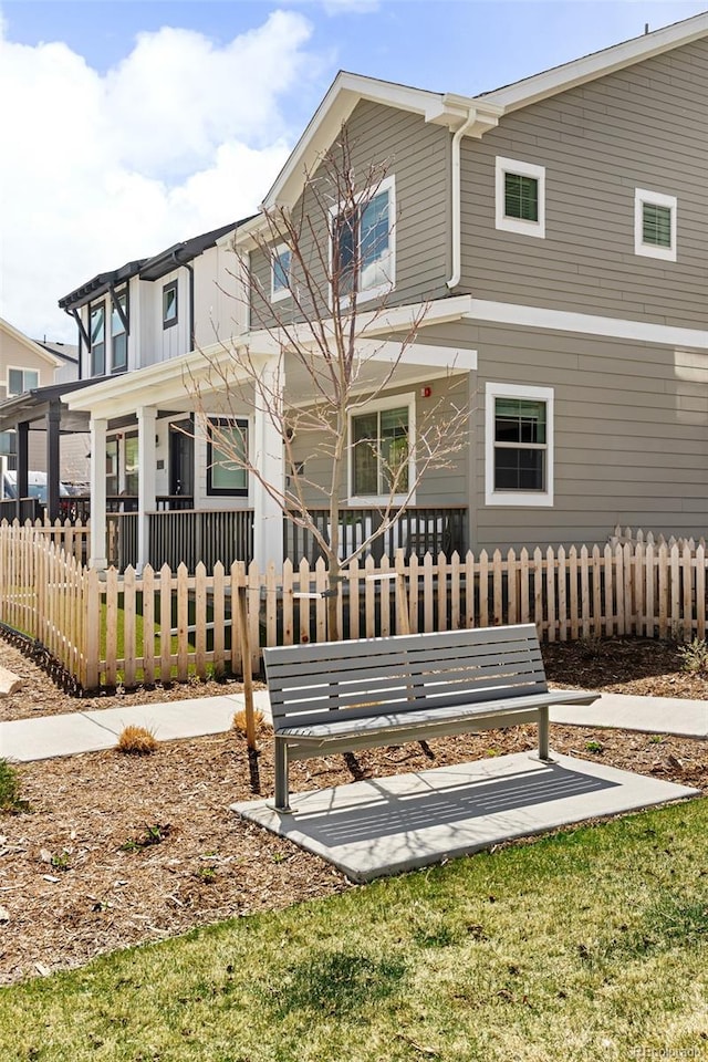 320 Marshall Mews, Superior, CO 80027 - rear view of house featuring covered porch and a fenced front yard