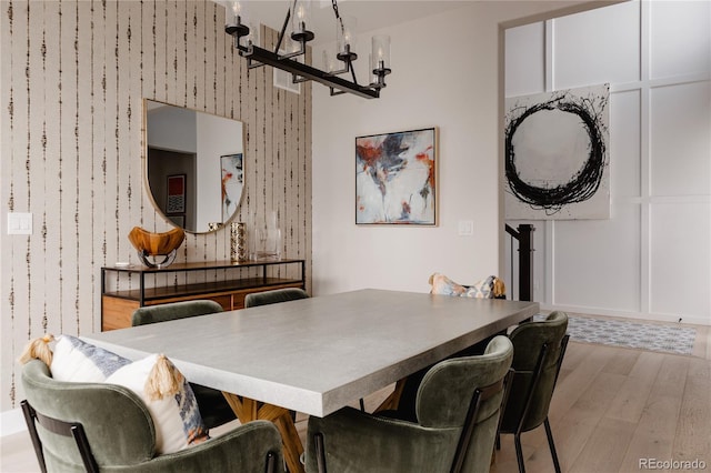 dining area with an inviting chandelier and wood finished floors