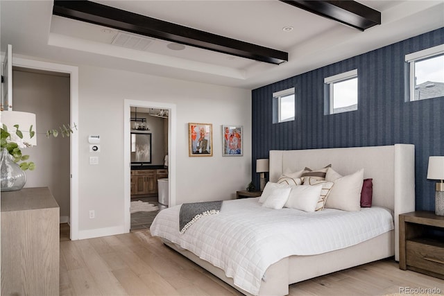 bedroom featuring light wood-type flooring, beam ceiling, baseboards, an accent wall, and wallpapered walls